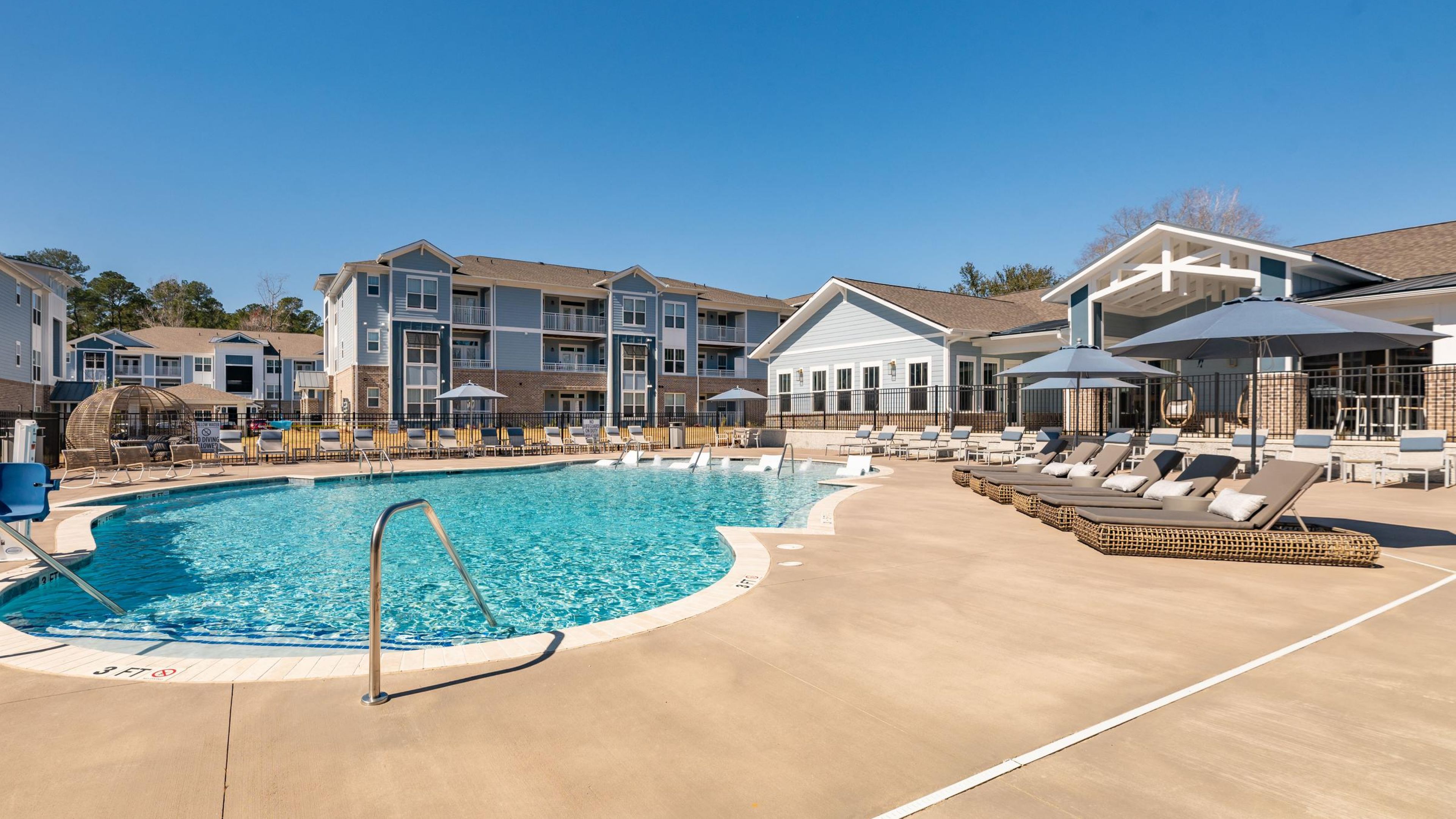 Hawthorne at Summerville large blue pool with comfortable lounge chairs around it.